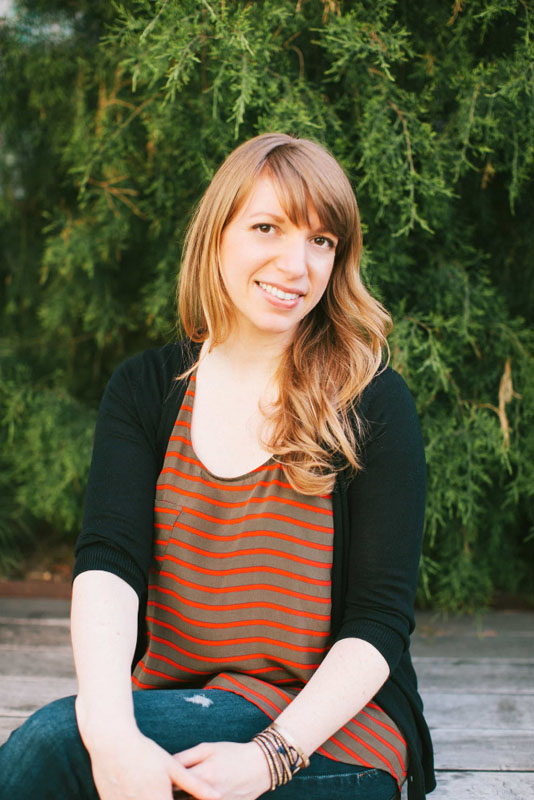 lara adler headshot sitting green background