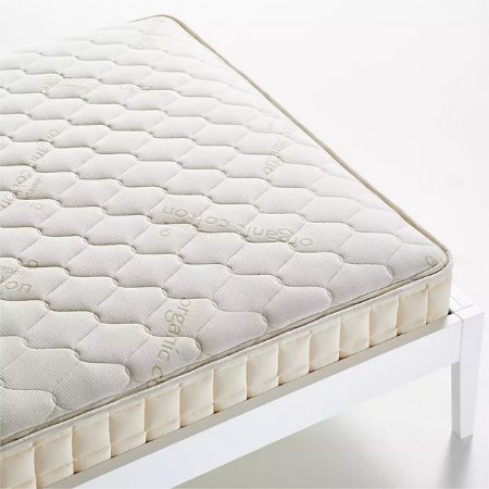 naturepedic organic mattress on white bed frame